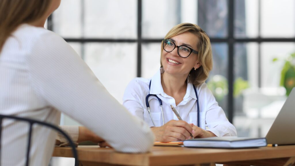 A psychiatrist supporting a client experiencing signs of emotional trauma in adults.