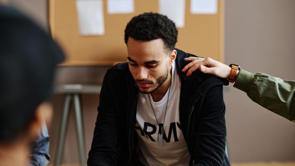 A man attending a therapy session to address the signs of emotional trauma in adults.