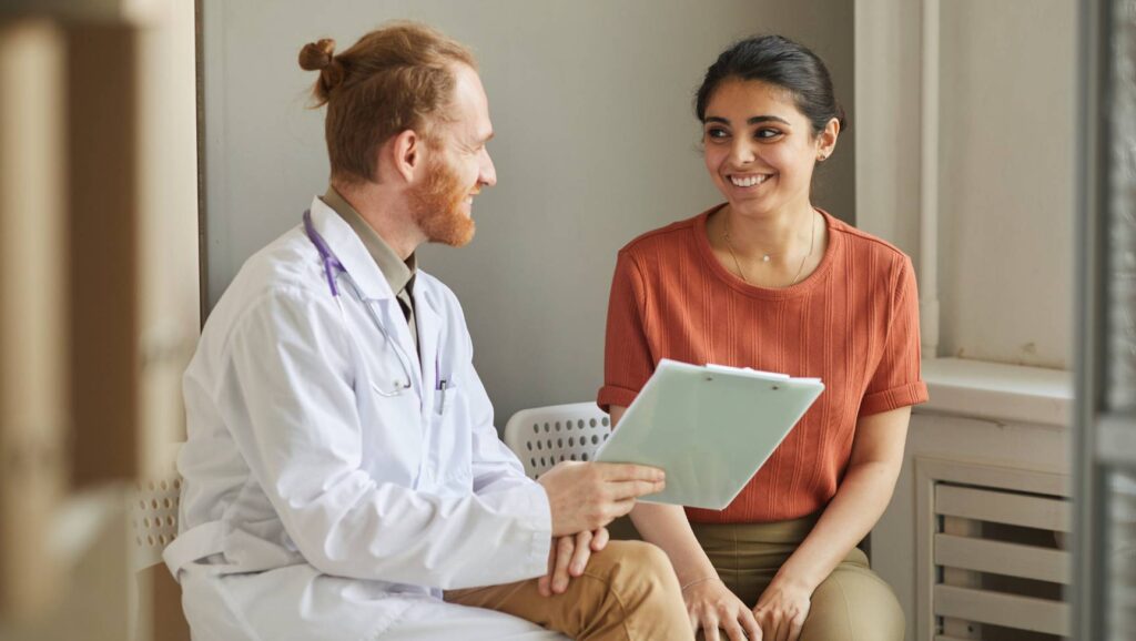 Psychiatrist assessing client’s progress during medication management.